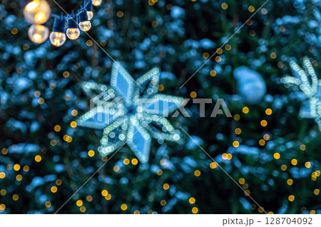 garland of light bulbs on defocused festive lights background, shallow depth of field, copy space garland of light bulbs on defocused festive lights background, shallow depth of field, copy space 128704092