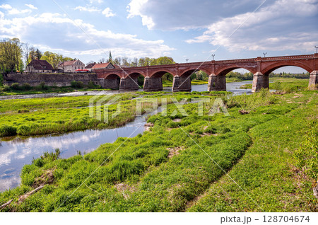 The old red brick bridge across the Venta river, built in 1874, Kuldiga, Latvia 128704674