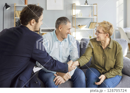 Consulting legal expert at home, senior mature family couple of clients meeting lawyer, solicitor Consulting legal expert at home, senior mature family couple of clients meeting lawyer, solicitor 128705724