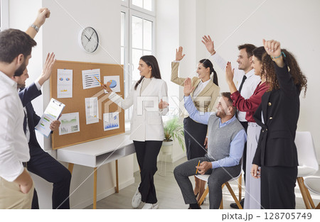 Successful office communication, coach, speaker during presentation to happy diverse businesspeople  128705749