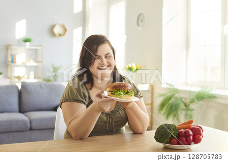 Obese hungry woman with excessive fat eating, choosing unhealthy fast food instead vegetables Obese hungry woman with excessive fat eating, choosing unhealthy fast food instead vegetables 128705783
