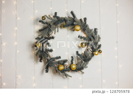 New Year's decor for a festive atmosphere. Decorating the room for Christmas. Golden toys for the Christmas tree New Year's decor for a festive atmosphere. Decorating the room for Christmas. Golden toys for the Christmas tree 128705978