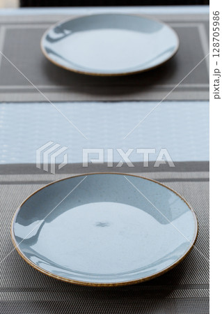 Empty plate of blue glaze ceramic melamine for dinner. 128705986