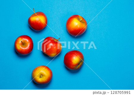 red-yellow juicy apples on a blue background. Healthy Nutrition and Vitamins 128705991
