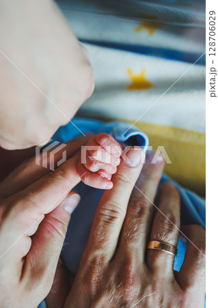 Newborn baby's hand close-up. A child's hand with a small palm Newborn baby's hand close-up. A child's hand with a small palm 128706029