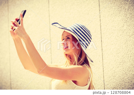 Young woman taking selfie with smartphone outside Young woman taking selfie with smartphone outside 128708804