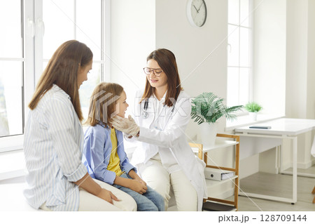 Pediatrician Attending Boy Patient With His Mother At The Hospital Pediatrician Attending Boy Patient With His Mother At The Hospital 128709144