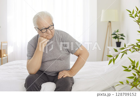 Sad Senior Man Reflecting In Bedroom At Home In The Morning Sad Senior Man Reflecting In Bedroom At Home In The Morning 128709152
