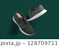 Modern Green Running Sneakers with White Soles on Green Background 128709711
