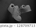 Minimalist grey sneakers on black stone background 128709713