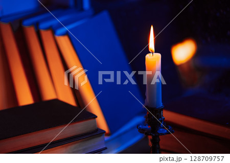 Vintage background. Stack of paper books near rainy window. Bronze candlestick. Vintage background. Stack of paper books near rainy window. Bronze candlestick. 128709757