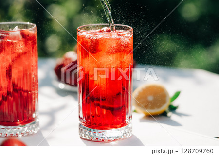 Amazing iced strawberry lemonade drinks. Still life, mojito cocktails for two. Amazing iced strawberry lemonade drinks. Still life, mojito cocktails for two. 128709760