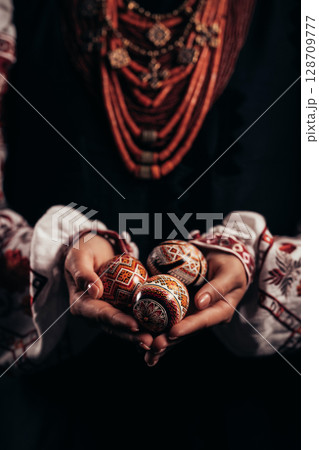 Ukrainian woman hand painted Easter egg. Beautiful geometric slavic decoration Ukrainian woman hand painted Easter egg. Beautiful geometric slavic decoration 128709777
