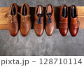 Elegant Brown Leather Shoes Collection on Wooden Shelf 128710114