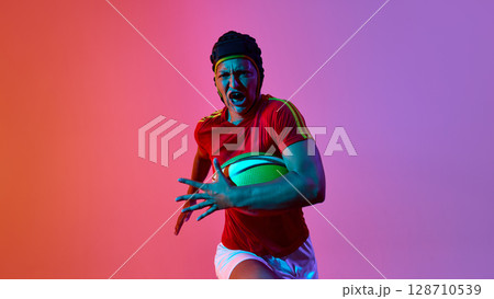 Female rugby athlete sprinting with resolve against vibrant backdrop Female rugby athlete sprinting with resolve against vibrant backdrop 128710539