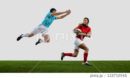 Dynamic rugby match with female athletes in action on field 128710548