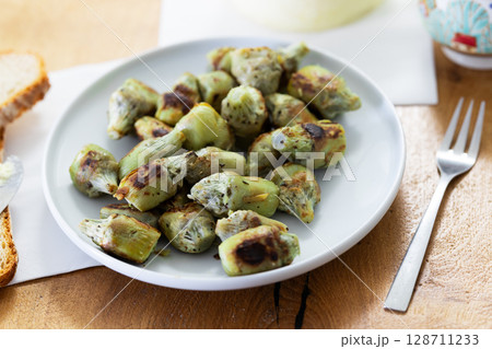 fried artichoke hearts on a plate 128711233