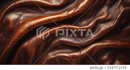 Close-up of smooth brown leather with soft folds, perfect for backgrounds, upholstery, and stylish design. 128711293