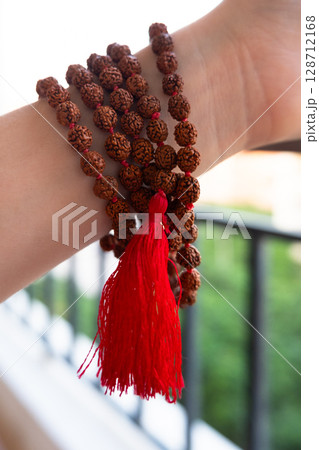 Japamala on the hand. Prayer beads. Religious equipment 128712168