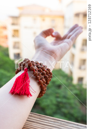 Japamala on the hand. Prayer beads. Religious equipment Japamala on the hand. Prayer beads. Religious equipment 128712169