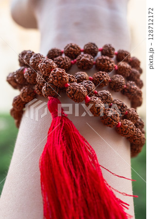 Japamala on the hand. Prayer beads. Religious equipment Japamala on the hand. Prayer beads. Religious equipment 128712172