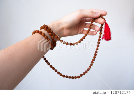 Japamala on the hand. Prayer beads. Religious equipment 128712174