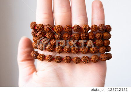 Japamala on the hand. Prayer beads. Religious equipment Japamala on the hand. Prayer beads. Religious equipment 128712181
