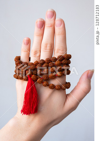 Japamala on the hand. Prayer beads. Religious equipment 128712183