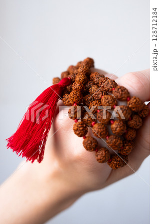 Japamala on the hand. Prayer beads. Religious equipment Japamala on the hand. Prayer beads. Religious equipment 128712184