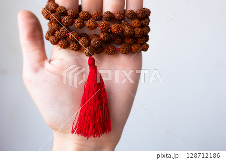 Japamala on the hand. Prayer beads. Religious equipment 128712186