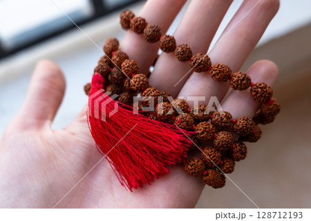 Japamala on the hand. Prayer beads. Religious equipment Japamala on the hand. Prayer beads. Religious equipment 128712193