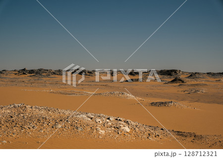 White rock formations and sand dunes in Egypt's White Desert, natural desert landscape	 128712321