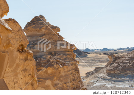White rock formations and sand dunes in Egypt's White Desert, natural desert landscape White rock formations and sand dunes in Egypt's White Desert, natural desert landscape 128712340