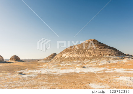 White rock formations and sand dunes in Egypt's White Desert, natural desert landscape White rock formations and sand dunes in Egypt's White Desert, natural desert landscape 128712353