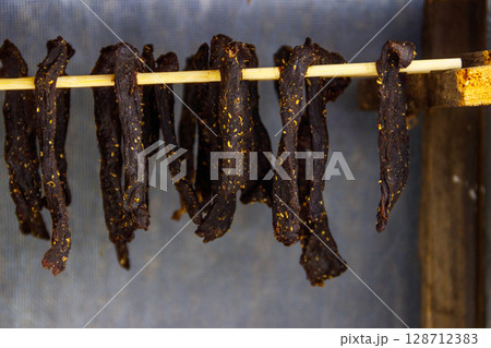 Preparing of South African dried meat or biltong Preparing of South African dried meat or biltong 128712383
