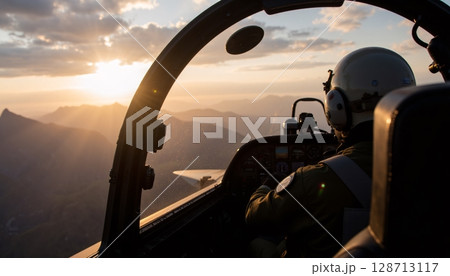 Pilot in Cockpit Flying Aircraft Above Mountains at Sunset with Scenic View of Horizon 128713117