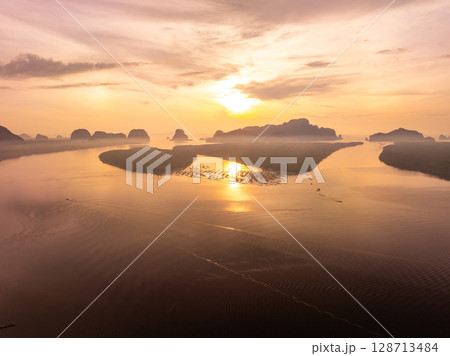 Drone view colorful sunset or sunrise sky over sea. Drone view colorful sunset or sunrise sky over sea. 128713484