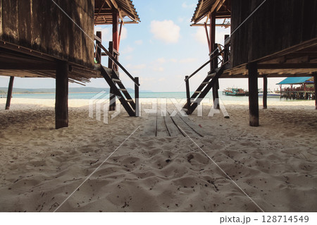 Stilt bungalow houses on a sandy beach create a calm and relaxing seaside view in Koh Rong Sanloem, Sihanoukville, Cambodia, a popular summer travel destination for tourism 128714549