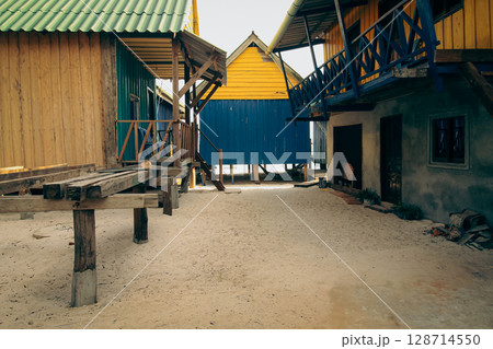 Rustic wooden houses with colorful facades on sandy ground of a beach village in Koh Rong Sanloem, Sihanoukville, Cambodia 128714550