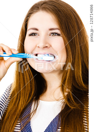 Woman brushing cleaning teeth. 128714866