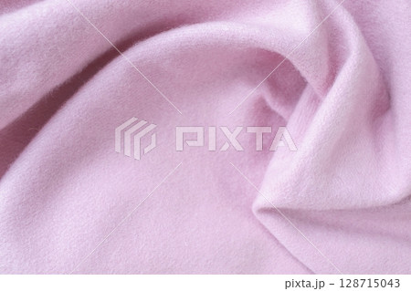 Cashmere pink stole. Texture, background, drapery. Fabric made of natural wool and silk, pastel pink color. 128715043
