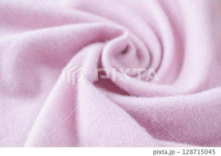 Cashmere pink stole. Texture, background, drapery. Fabric made of natural wool and silk, pastel pink color. 128715045