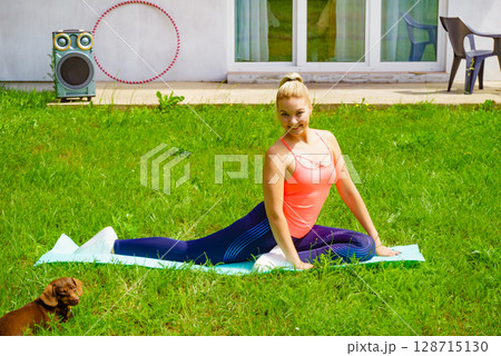 Woman doing exercises gym in garden at home 128715130
