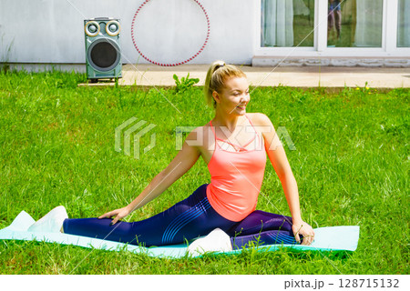 Woman doing exercises gym in garden at home 128715132