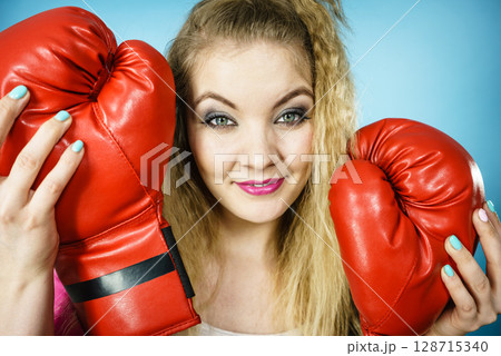 Funny girl with red gloves playing sports boxing Funny girl with red gloves playing sports boxing 128715340