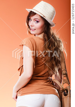 Lovely woman in summer hat handbag portrait Lovely woman in summer hat handbag portrait 128715403