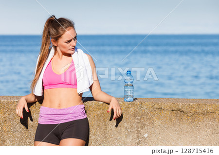 Woman drinking water after sport gym outdoor Woman drinking water after sport gym outdoor 128715416