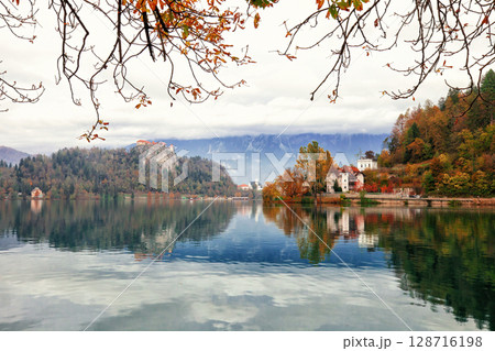 Autumn landscape with lake Bled and old villa by blue sky in Slovenia 128716198