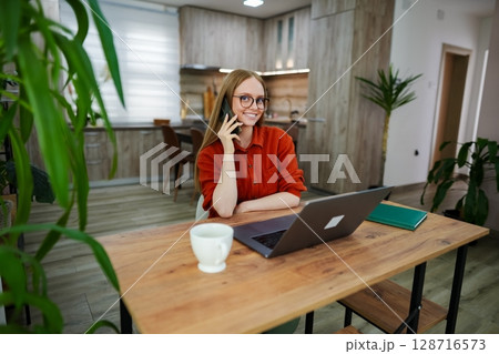 Bright and cozy indoor workspace with a woman on a call 128716573