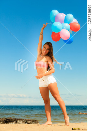 Girl holding balloons sky background Girl holding balloons sky background 128716696